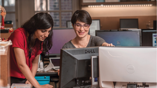 Two students working on a computer.