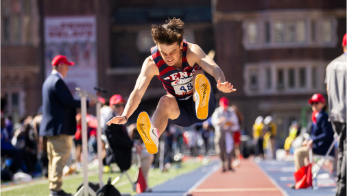 Student track and field athlete competing in long jump.